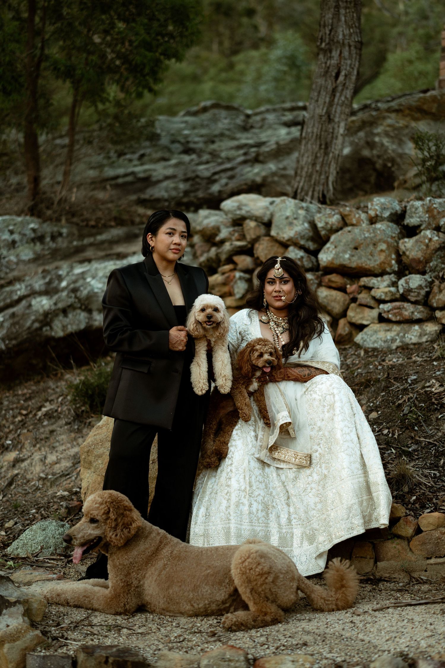 Wedding couple walks together on forest path surrounded by lush greenery.