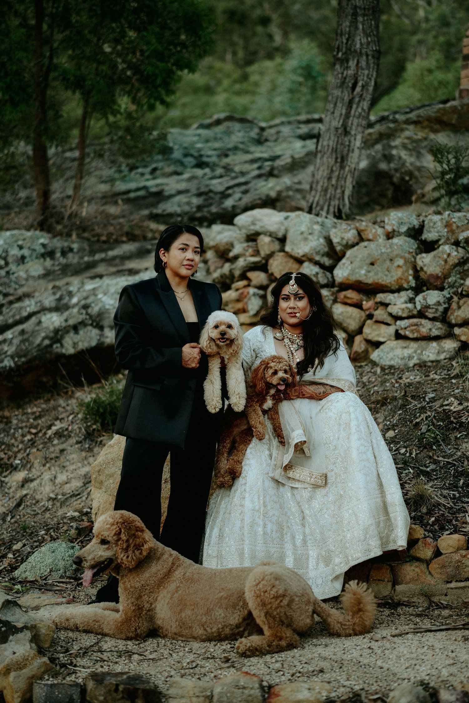 Wedding couple walks together on forest path surrounded by lush greenery.