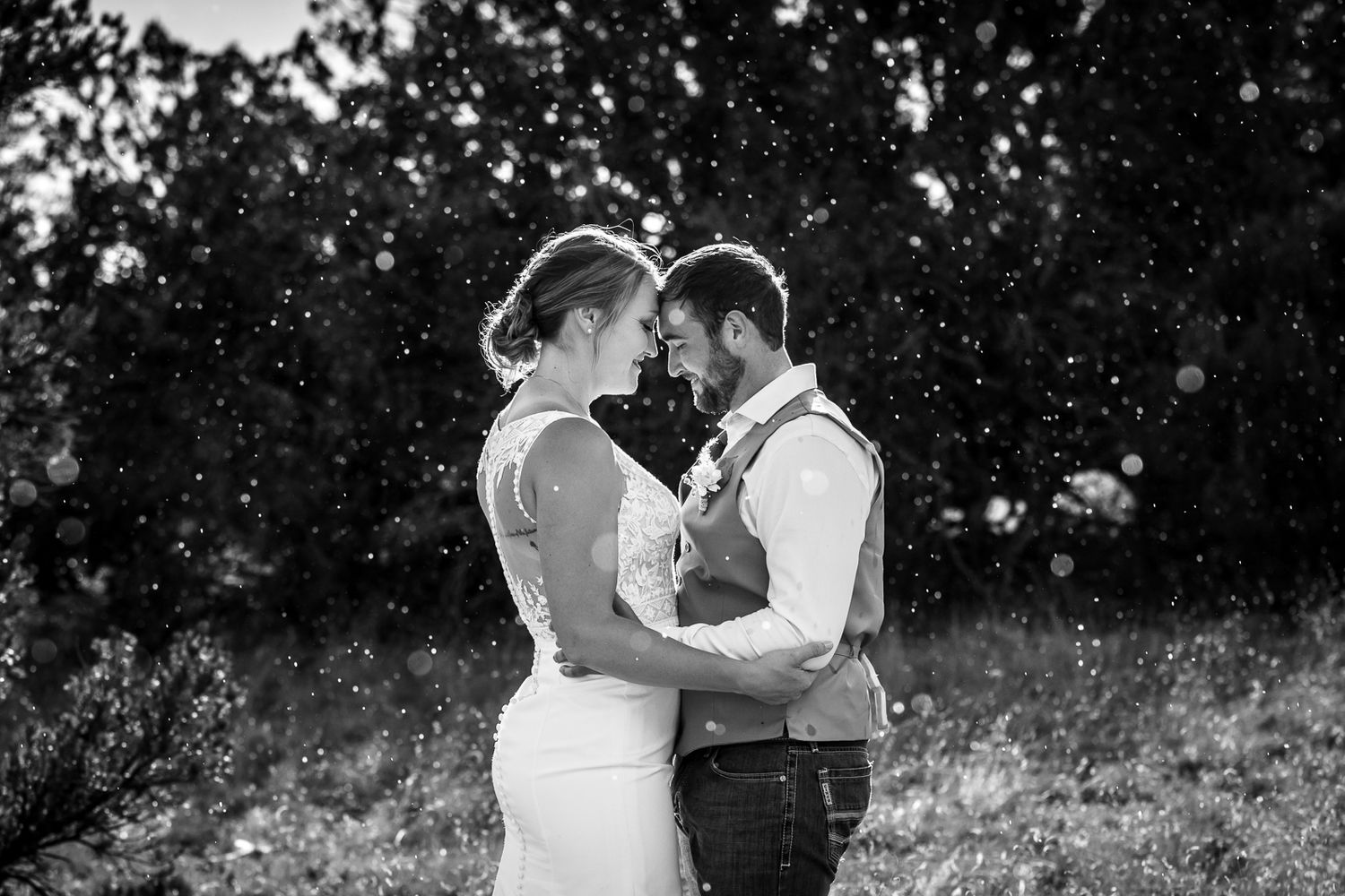 Beautiful outdoor black and white wedding photography; couple embracing in the rain; Clarissa Anello