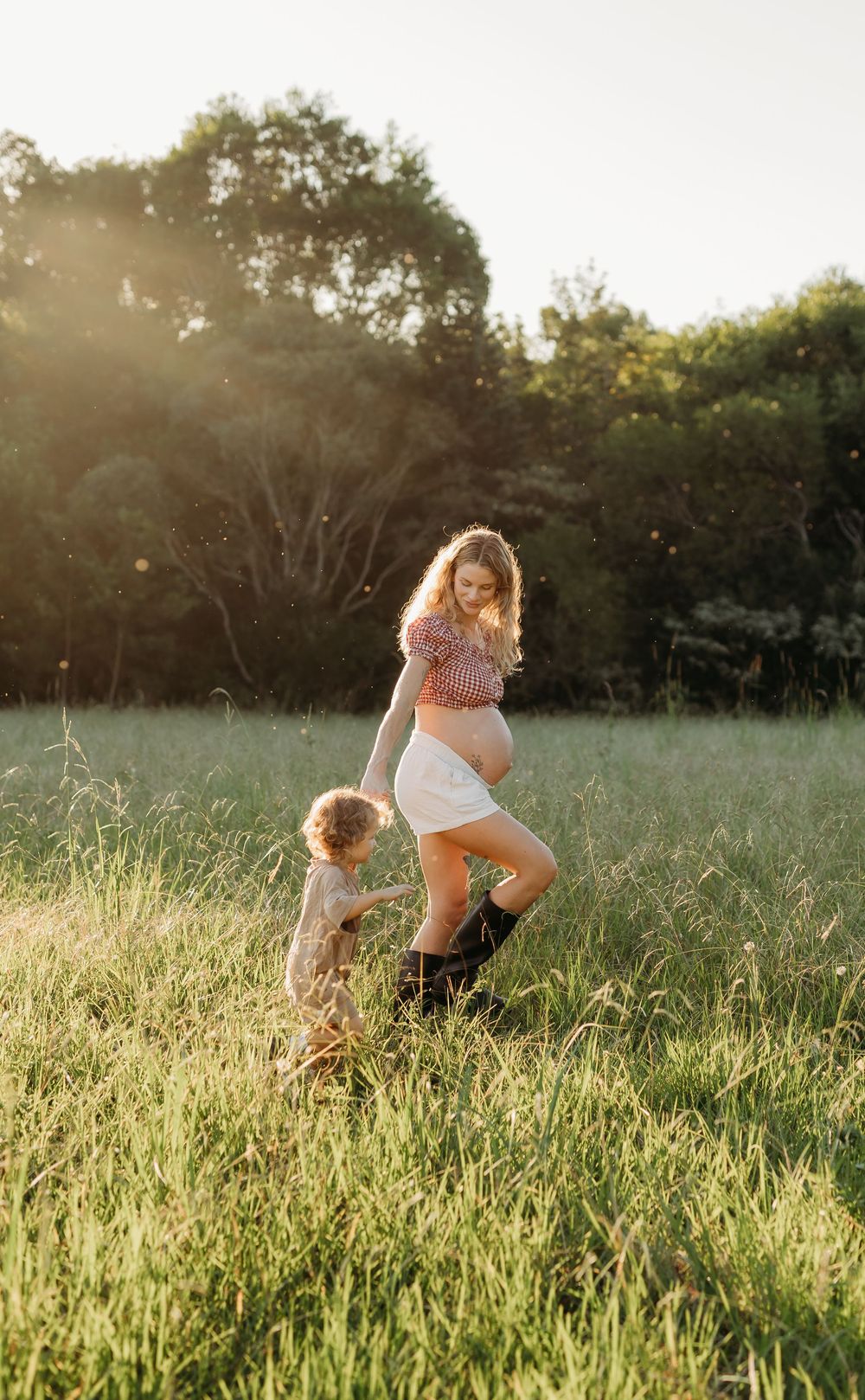 Pregnant mother with her toddler in a field, family maternity session