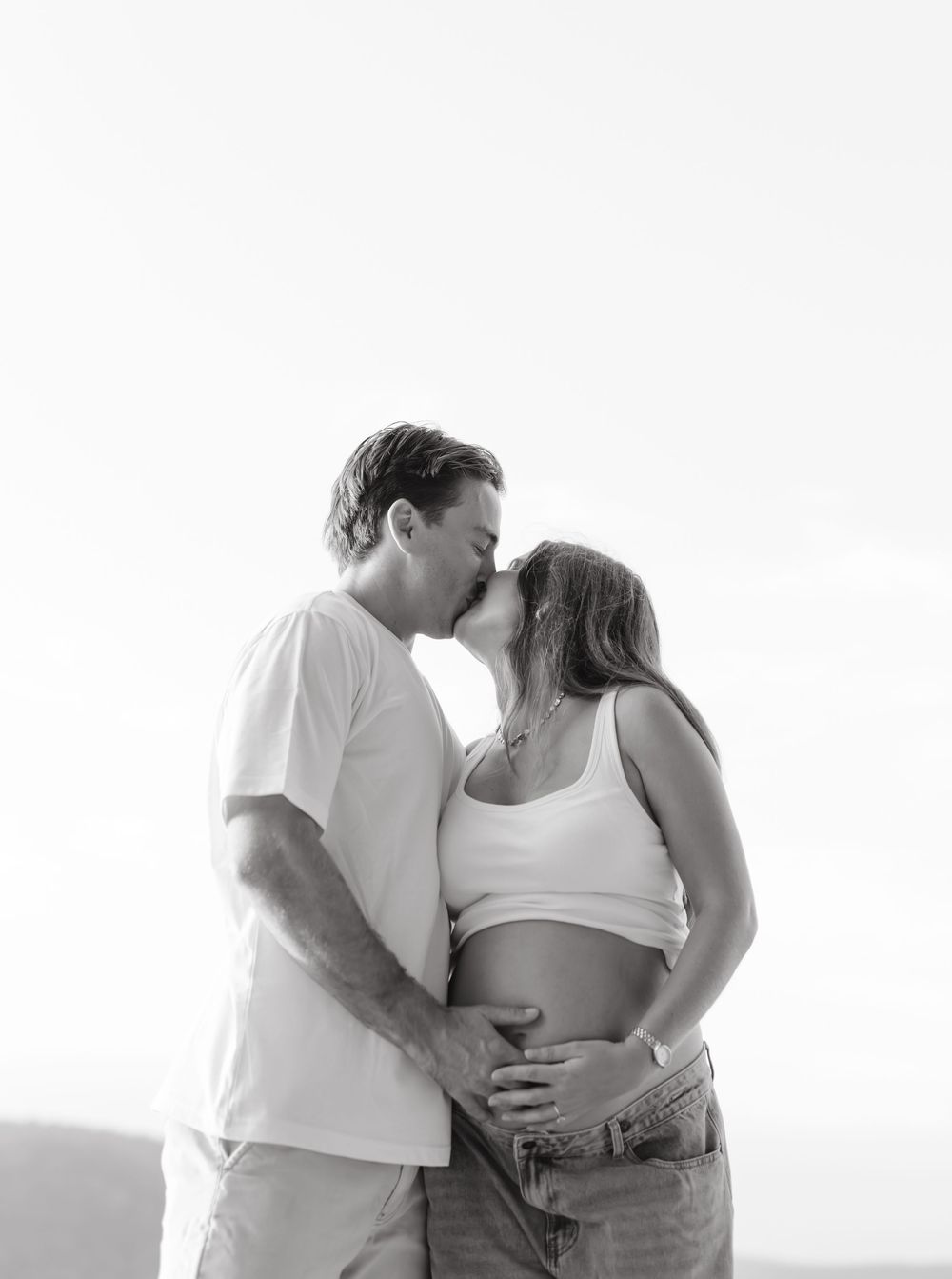 Couple kissing during maternity photoshoot, Sunshine Coast
