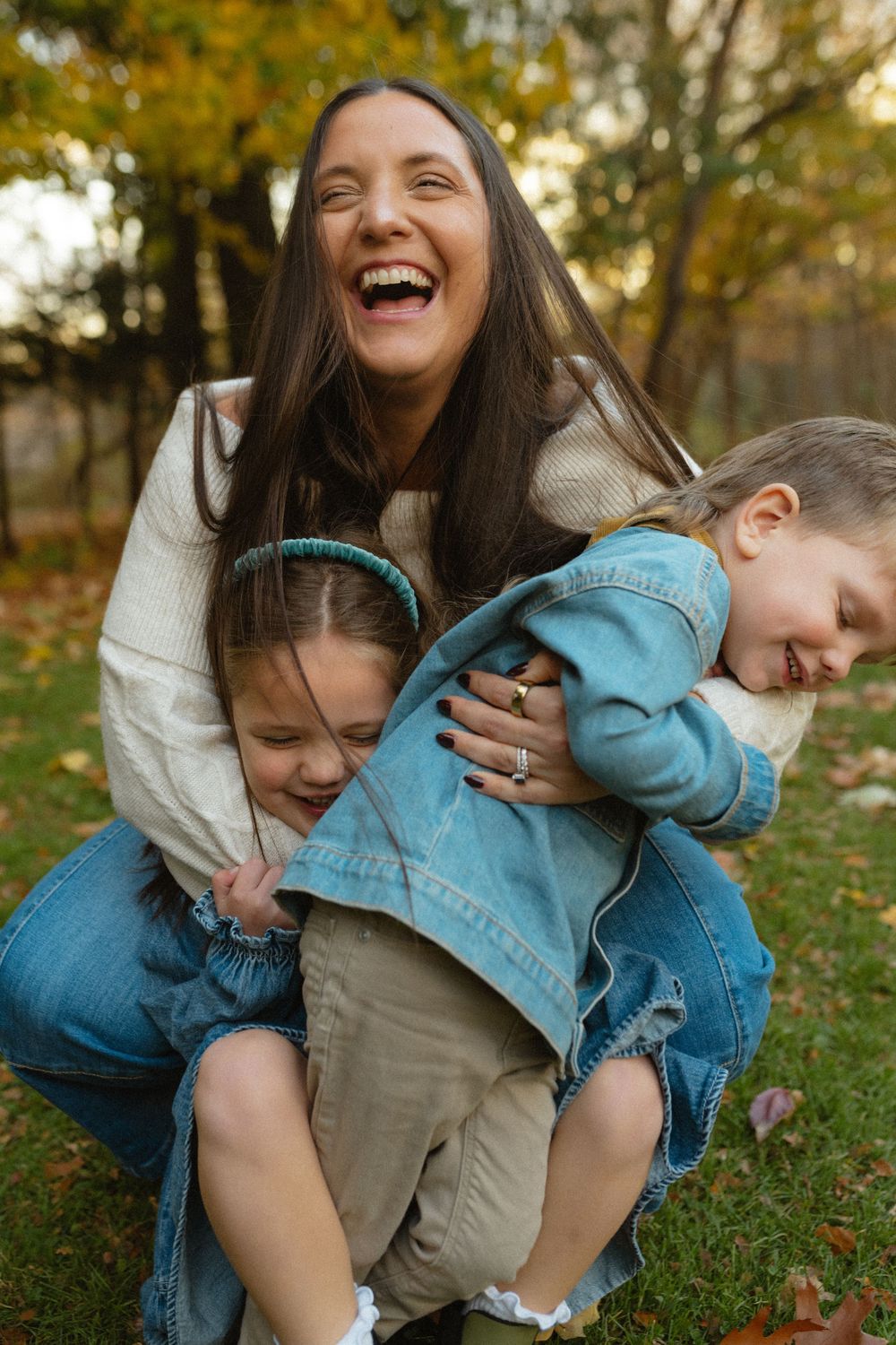 Playful candid moments captured in a series of autumn outdoor photos showing joyful laughter and embraces.