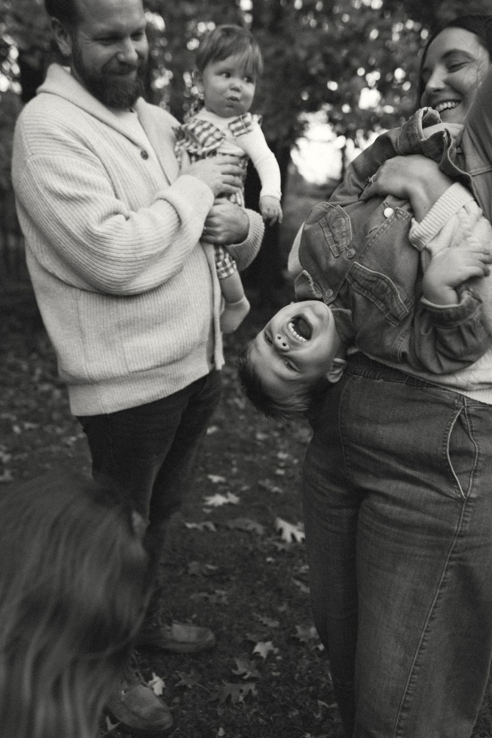 A black and white photo sequence shows a parent in a sweater playfully interacting with a laughing toddler outdoors.