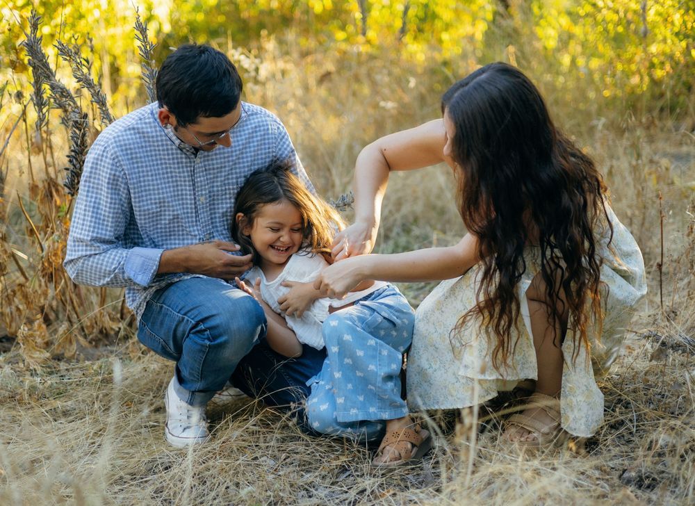 A series of candid moments captured in a golden fall meadow showing people relaxing and interacting outdoors.