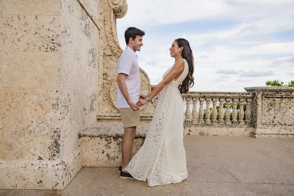 A romantic portrait against weathered stone architecture and balustrades.
