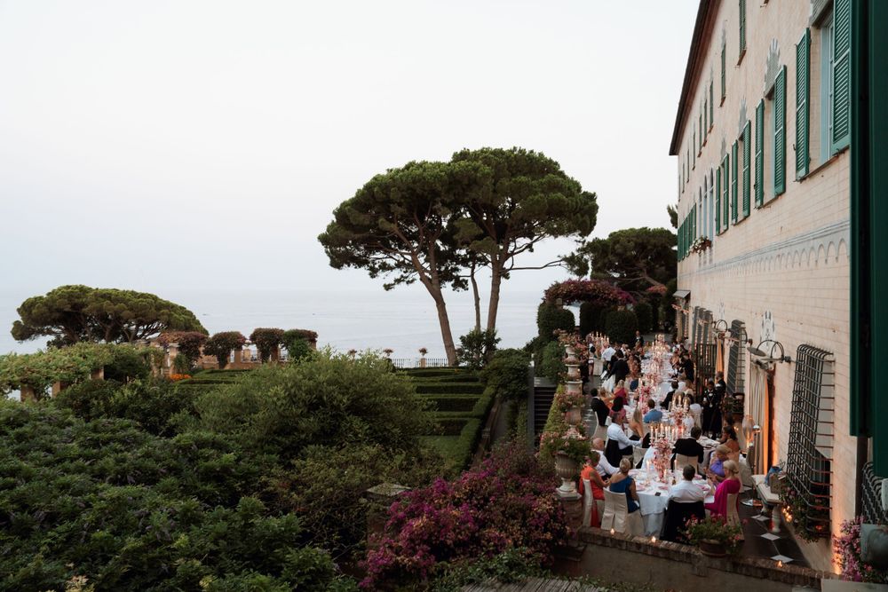 Outdoor wedding reception setup on a terrace overlooking Mediterranean pine trees and coastal views in portofino