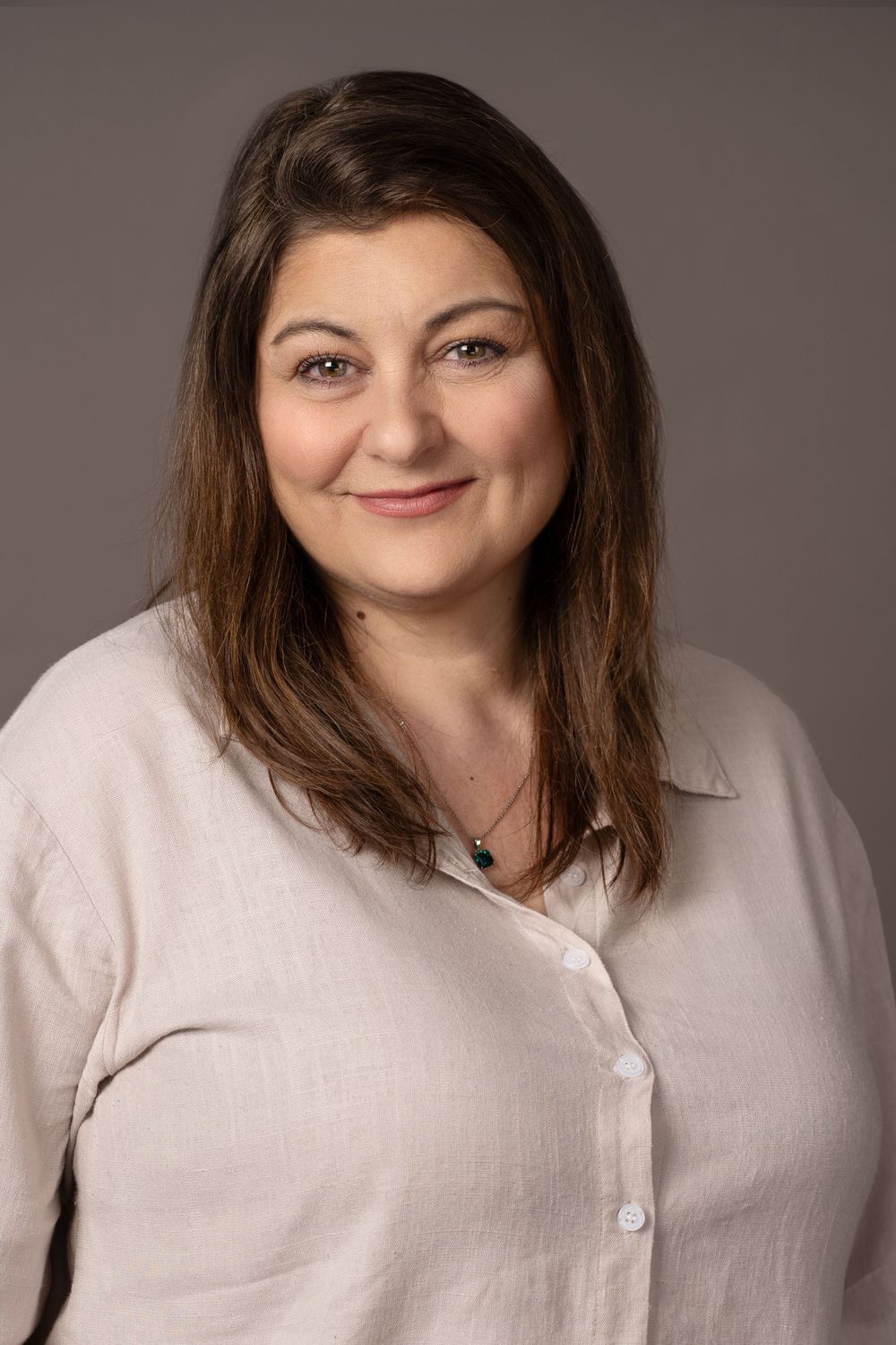 Professional headshots series in natural linen top against neutral background.