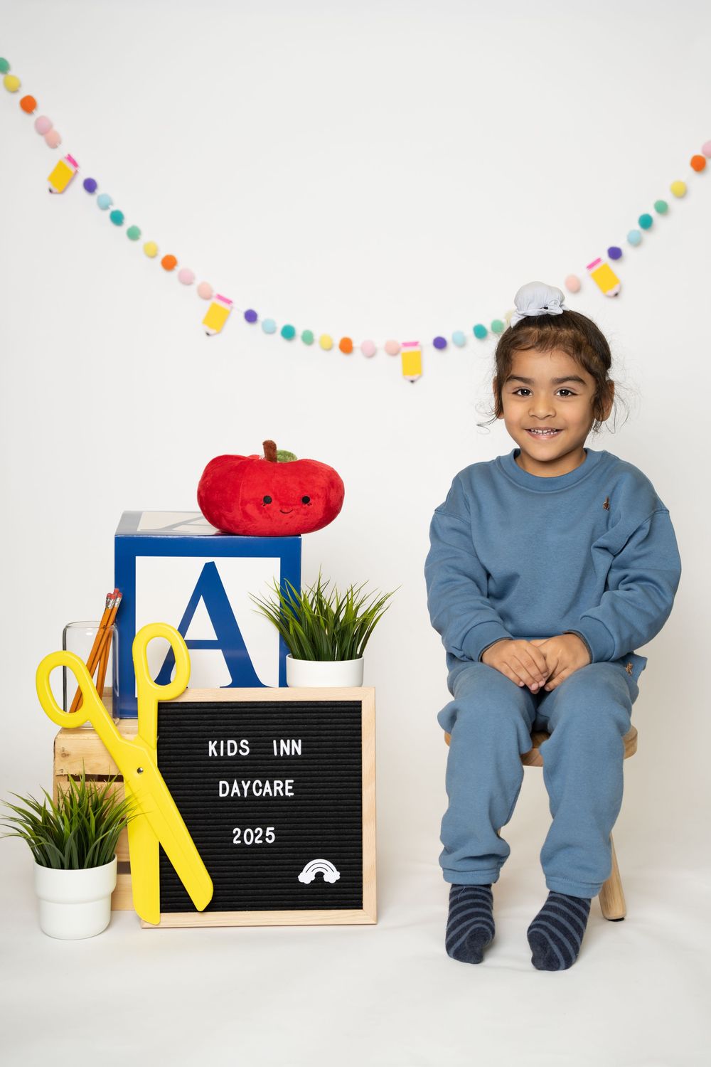 Collage of daycare or kids inn promotional photos showing decorative elements, letter boards, and blue clothing details.