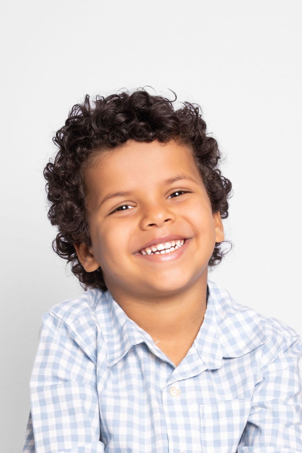 Series of close-up portraits showing joyful expression in blue gingham shirt.