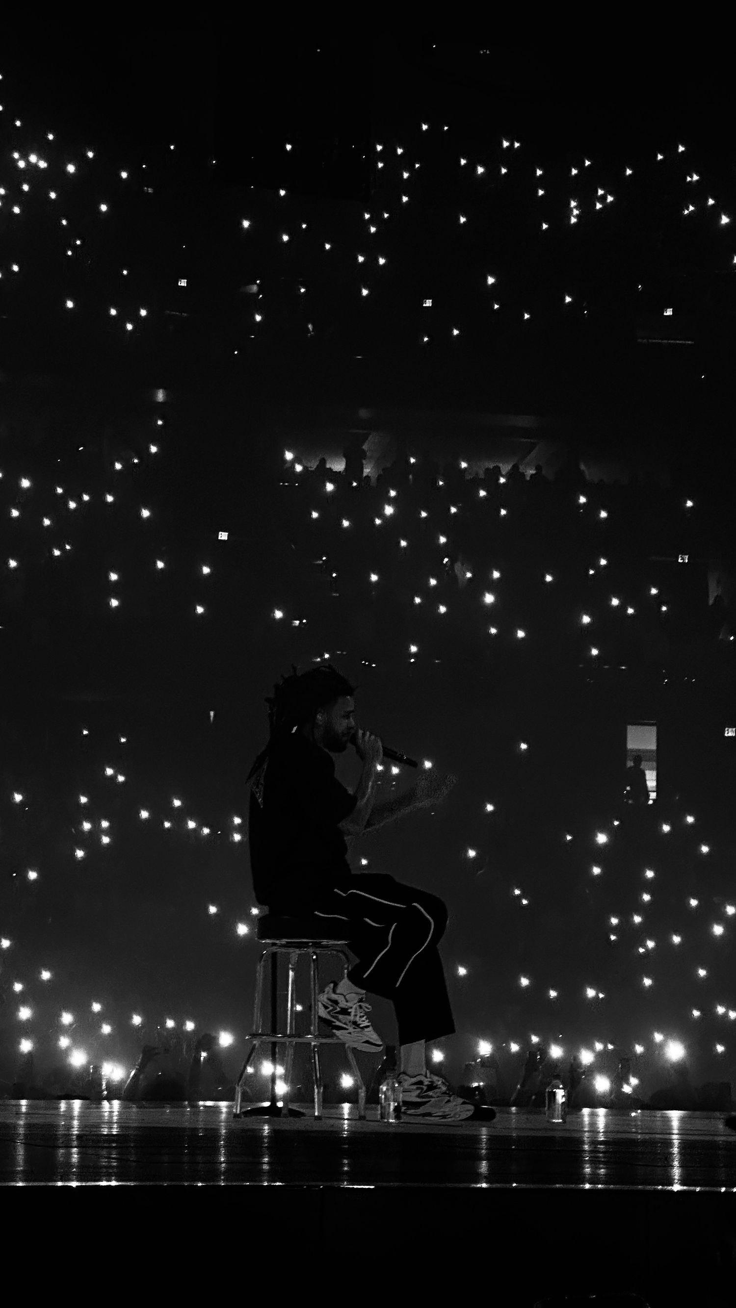String lights illuminate a dark outdoor scene with silhouetted figures beneath.