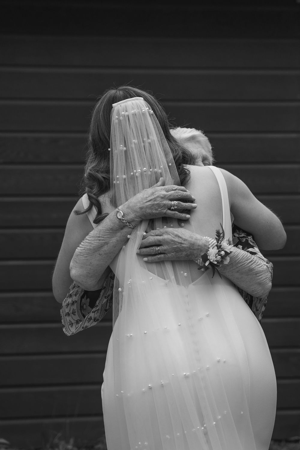 bride and grandmother hugging and sharing a tender moment