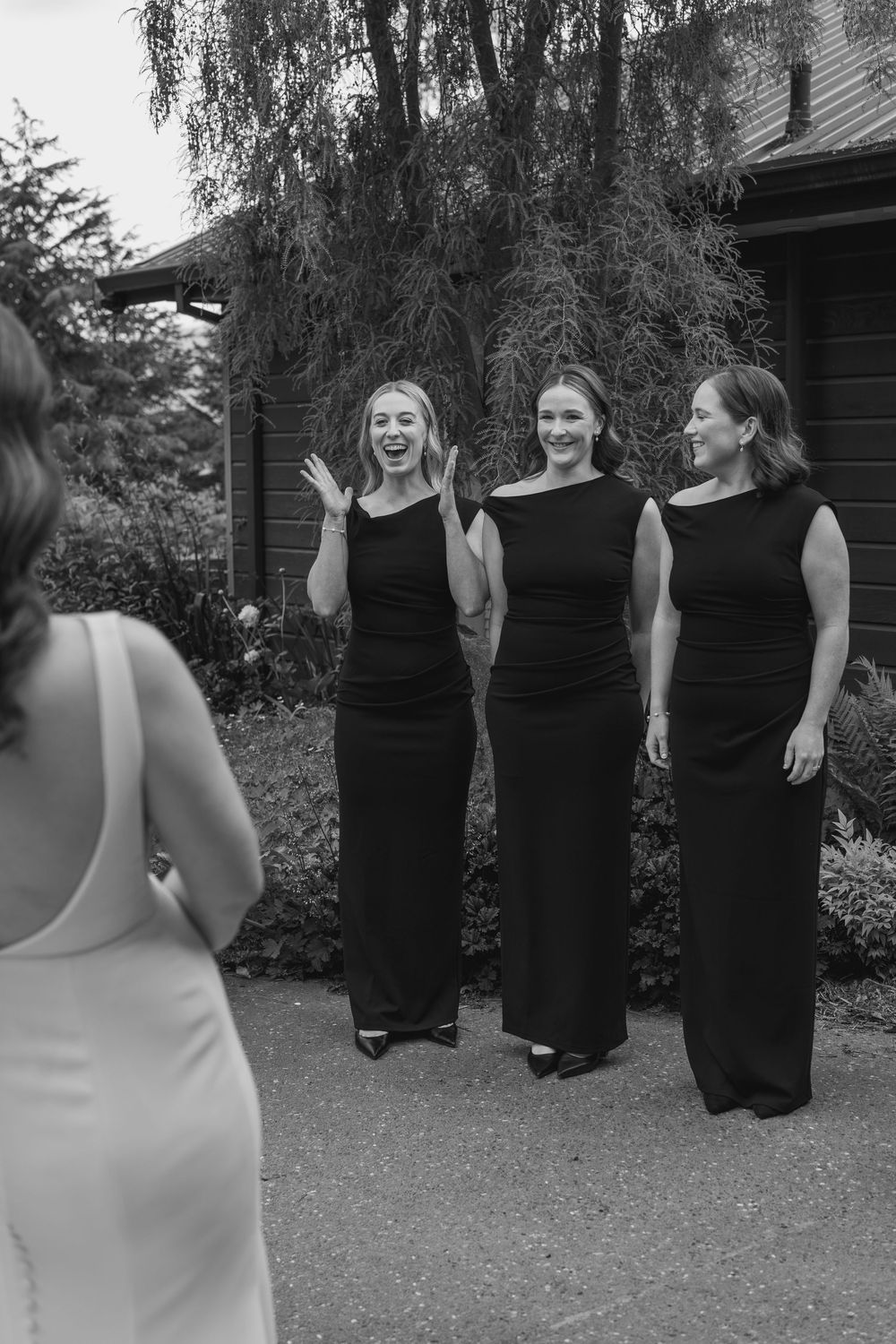 bridesmaids seeing the bride dressed for the first time