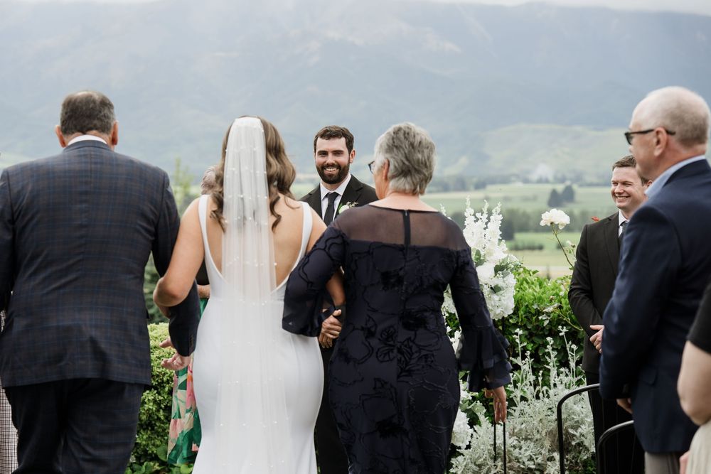 Father and Mother walking the bride down the isle to her future husband during the wedding ceremony at Amuri Estate
