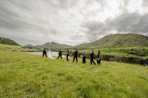 Bridal party walking in a paddock above the Waiau River in Hanmer