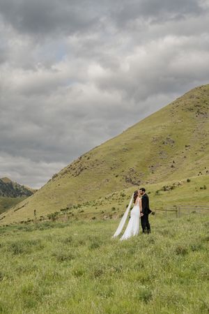 Wedding couple posed in a paddock in the hills around Hanmer Springs