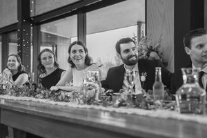 Bridal party laughing during speeches at a wedding Amuri Estate