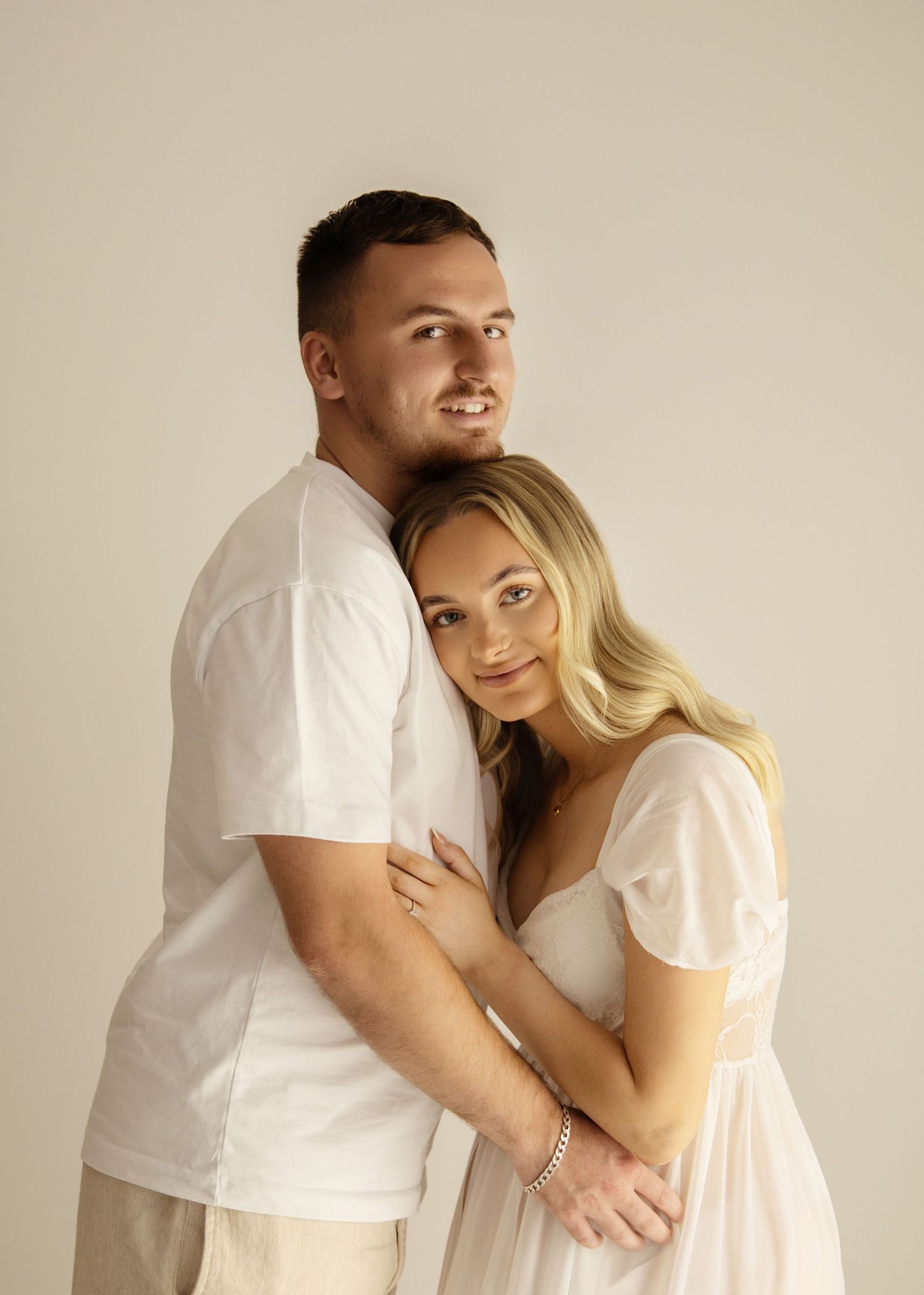 Beautiful neutral theme image of expectant mum & Dad  smiling, taken in my Coventry Studio