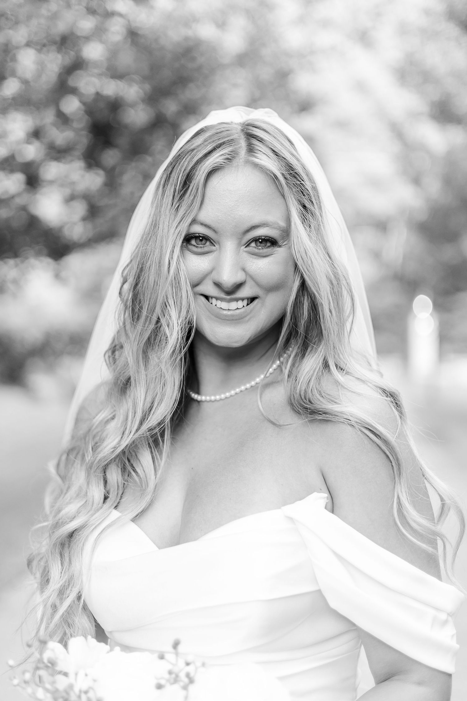 Close-up black and white bridal portraits showing elegant makeup and pearls.