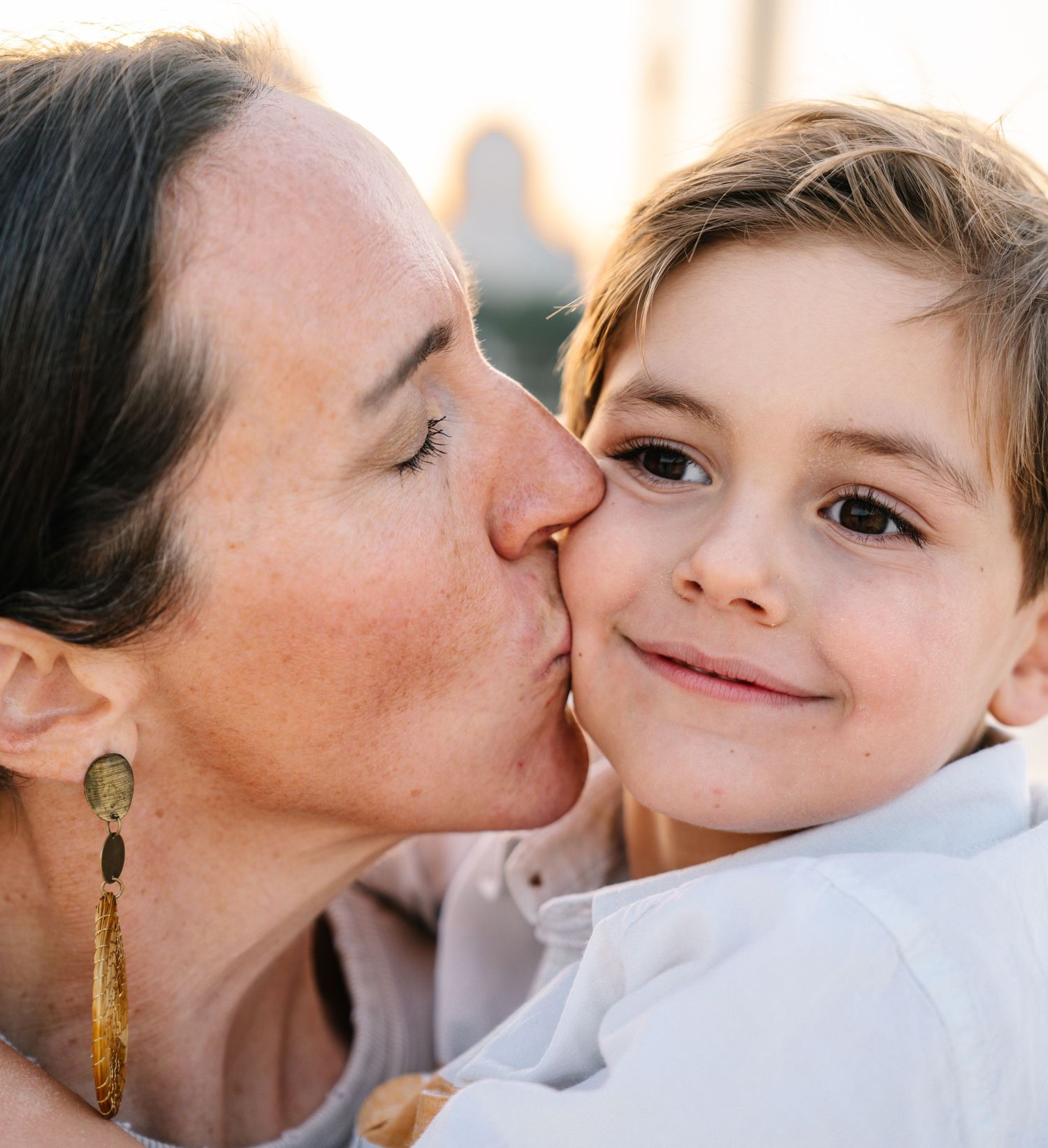 Tender moment captured between parent and child during golden hour.