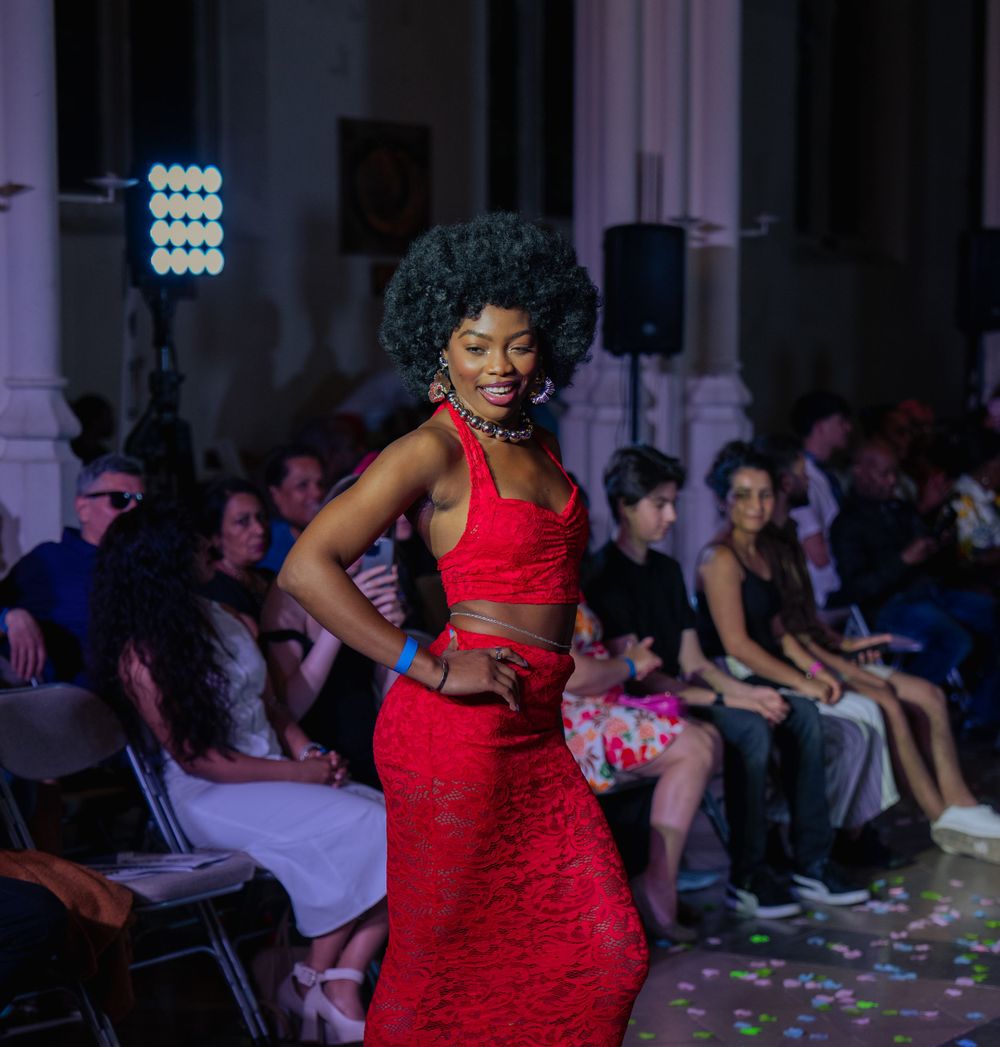 female runway in red dress with afro