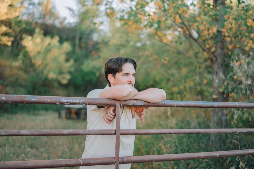 Man at a barn posing for portrait photo