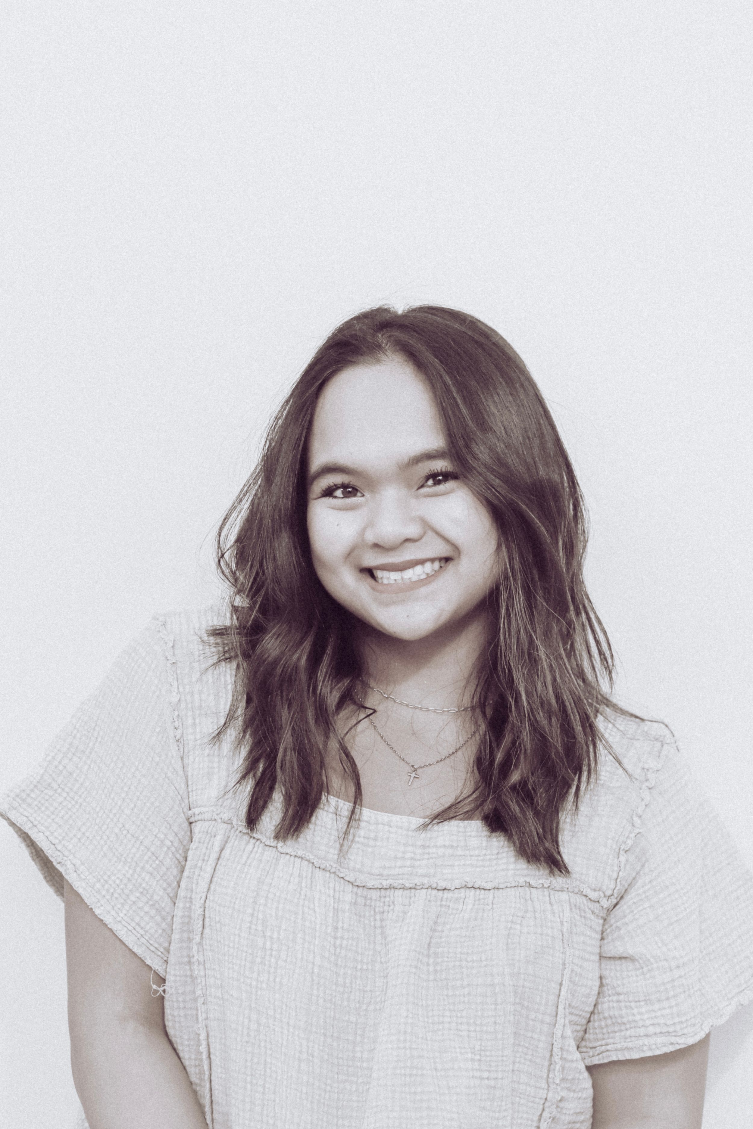 A white studio portrait session featuring casual attire and natural expressions.