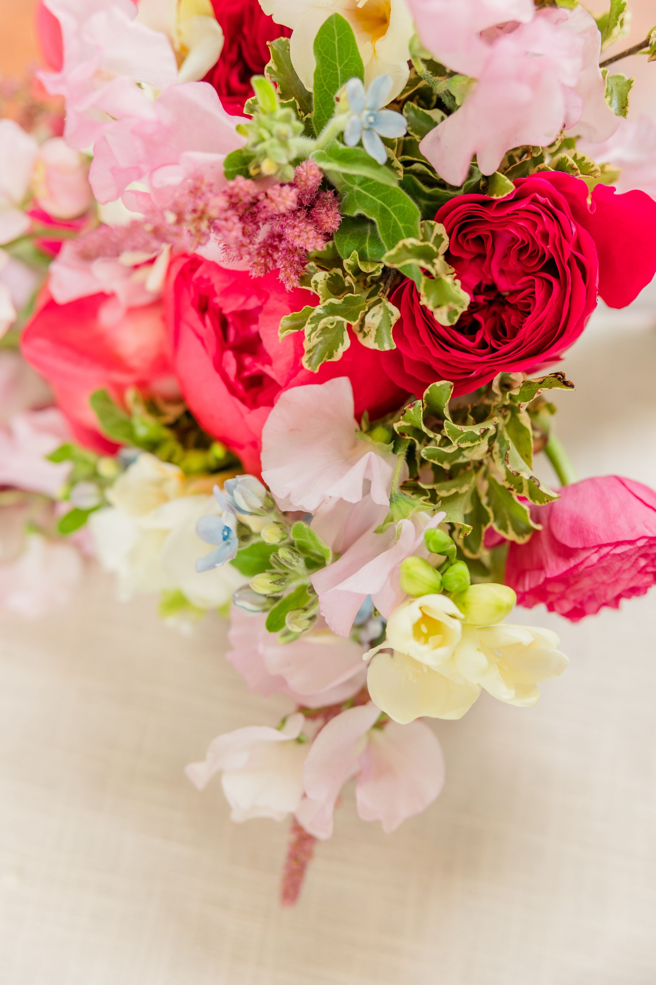 A stunning floral arrangement featuring pink and red roses with delicate white blooms.