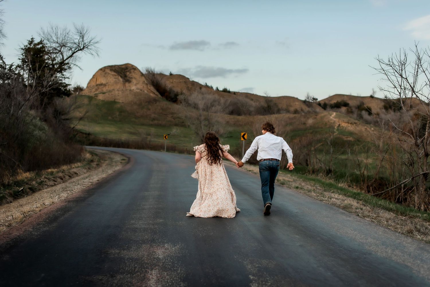 People enjoying a beautiful sunset moment together on a hilltop overlooking a scenic landscape.