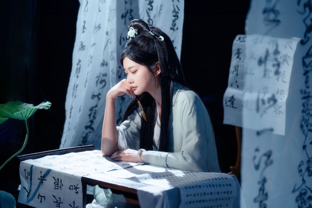 Elegant solo Hanfu portrait of a woman writing calligraphy among traditional script banners, by Imagine Image Studio.
