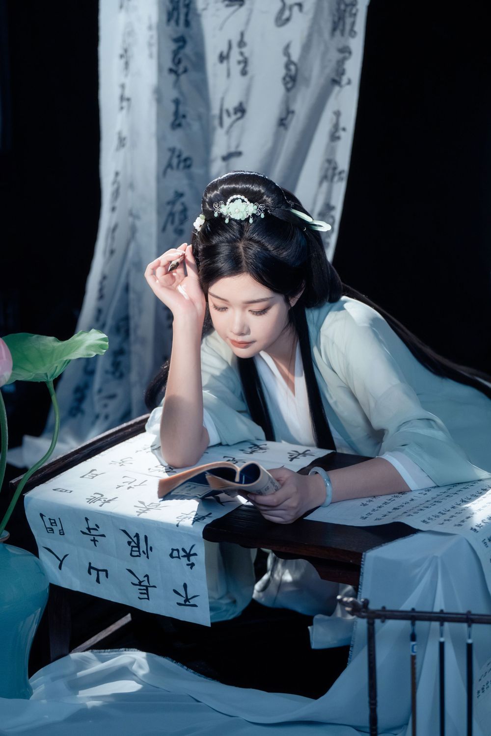 Elegant solo Hanfu portrait of a woman writing calligraphy among traditional script banners, by Imagine Image Studio.