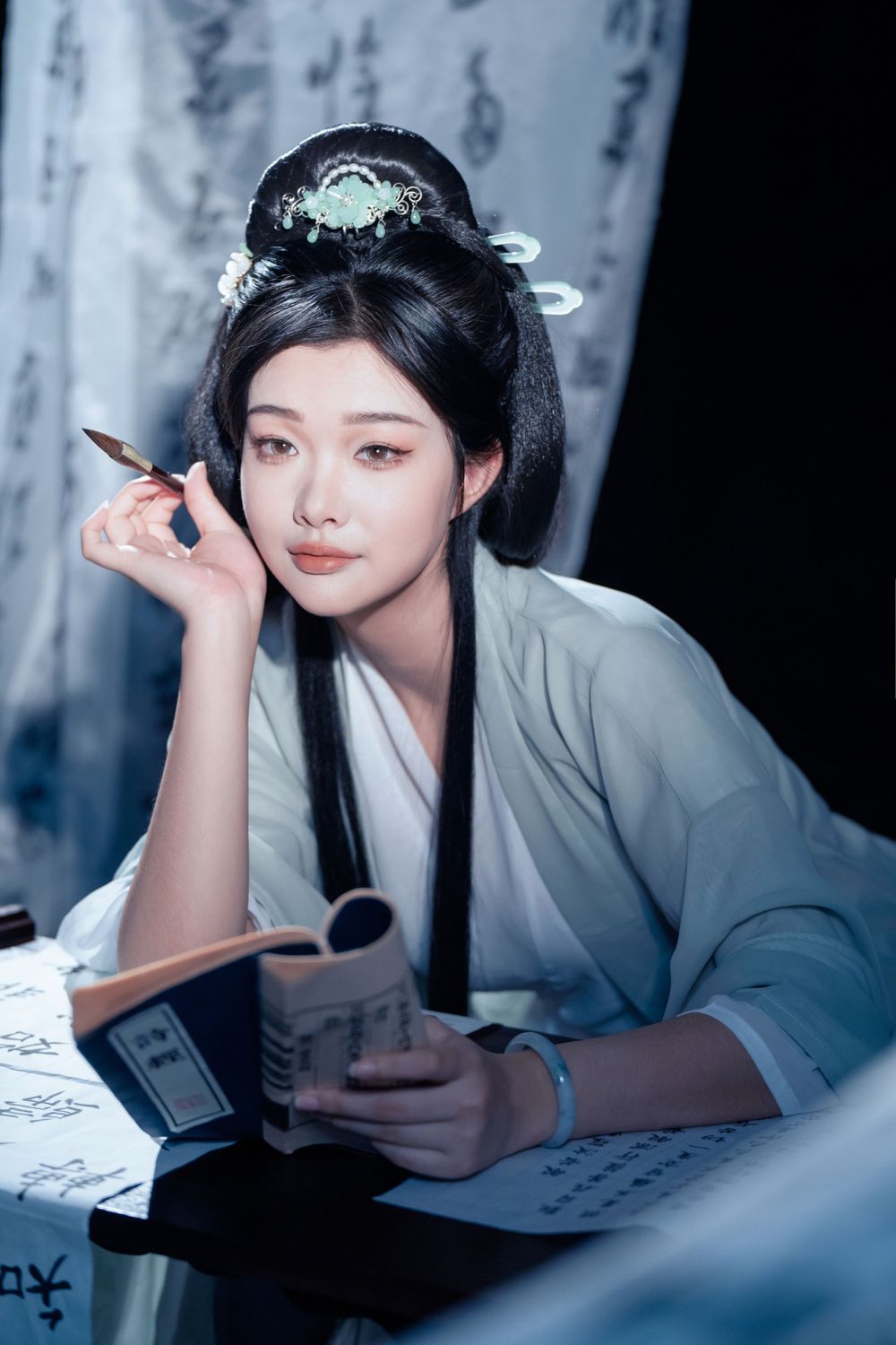 Elegant solo Hanfu portrait of a woman writing calligraphy among traditional script banners, by Imagine Image Studio.