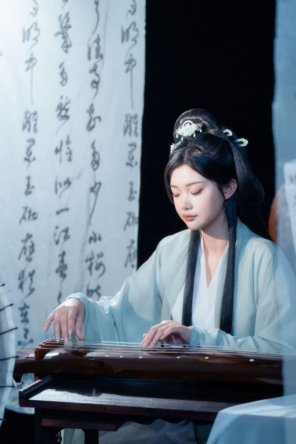 Serene and ethereal Hanfu photography of a woman playing Guqin surrounded by calligraphy scrolls, by Imagine Image Studio.
