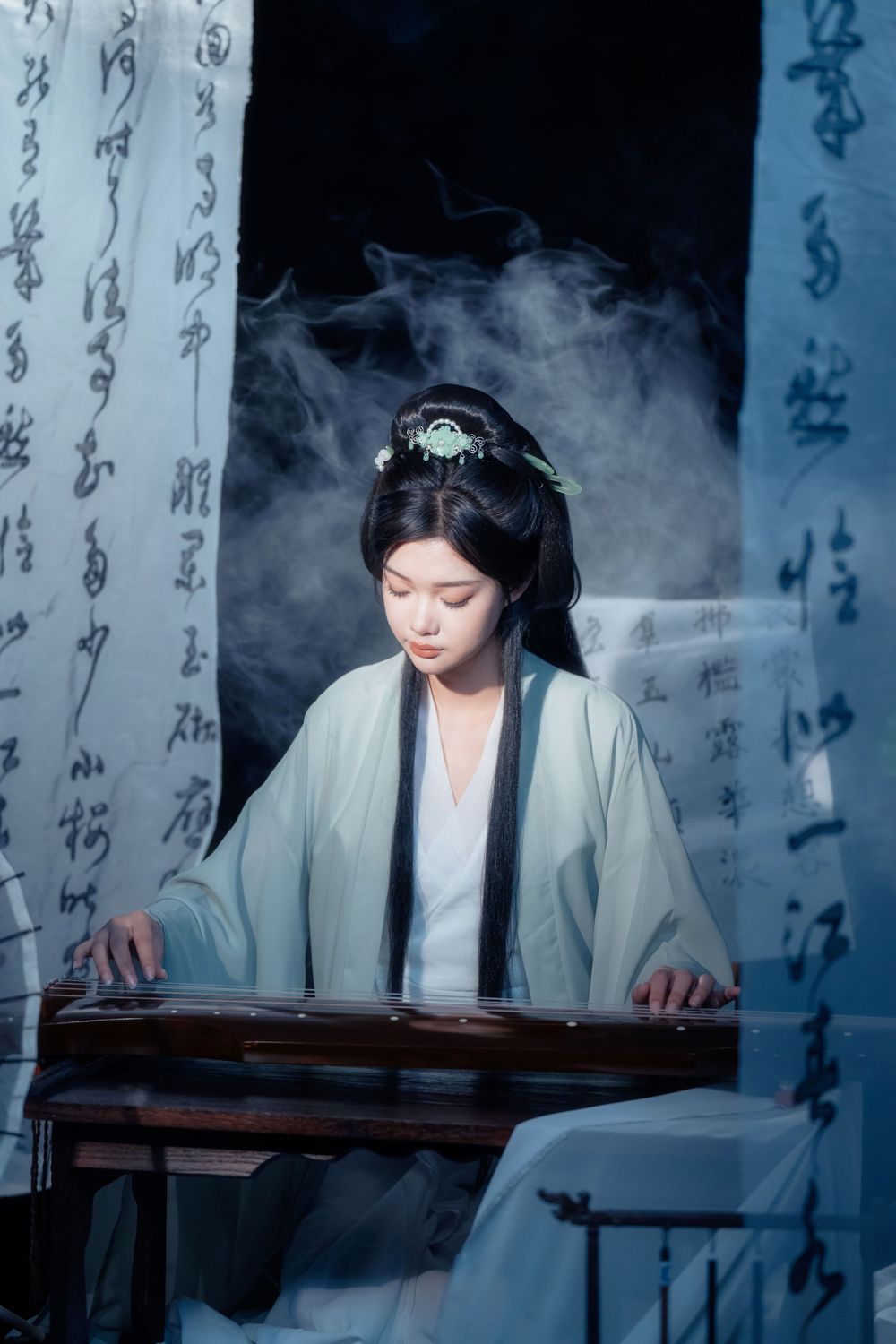 Elegant solo Hanfu portrait of a woman writing calligraphy among traditional script banners, by Imagine Image Studio.