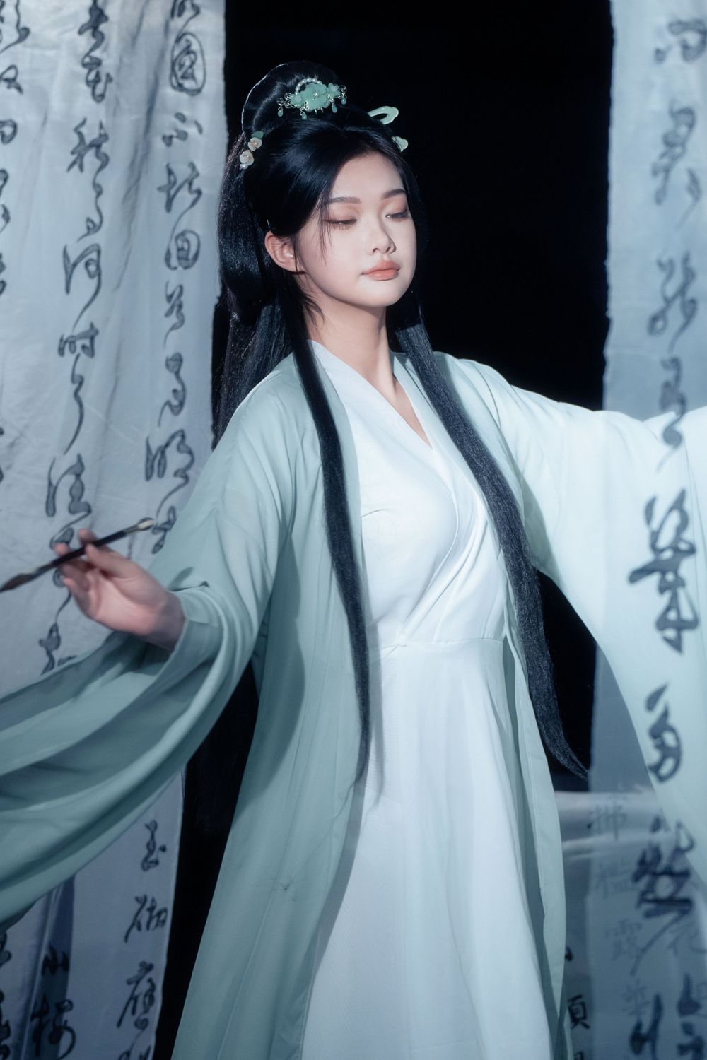 Quiet and elegant solo Hanfu portrait featuring traditional Chinese calligraphy backdrops, captured by Imagine Image Studio.