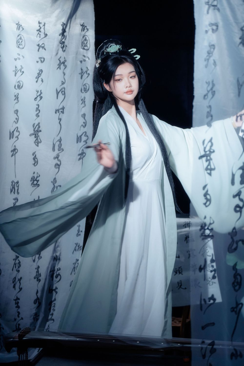 Quiet and elegant solo Hanfu portrait featuring traditional Chinese calligraphy backdrops, captured by Imagine Image Studio.