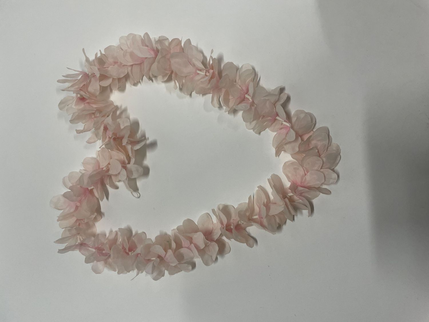 Heart-shaped arrangement of delicate pink crystal or quartz fragments.