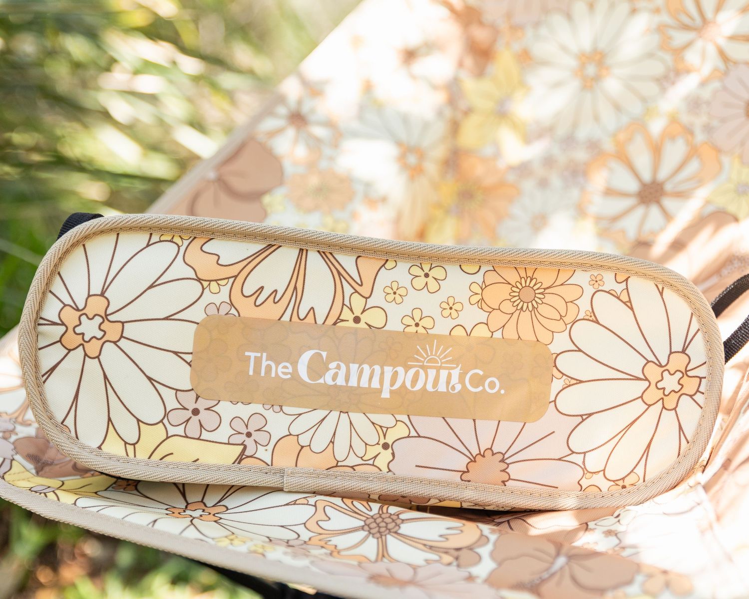 Decorative floral pattern design featuring daisies and The Campout Co branding.
