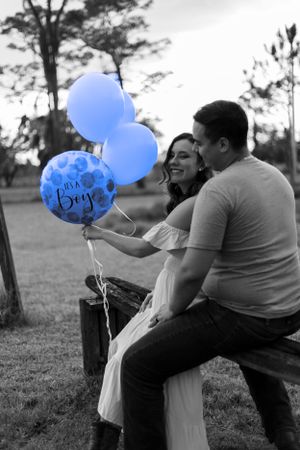 Black and white photo with a pop of blue baby boy balloons in an outdoor setting. Geneva, Florida