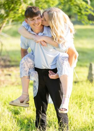 Romantic piggyback ride in sunny field with couple in coordinating outfits. Geneva, Florida