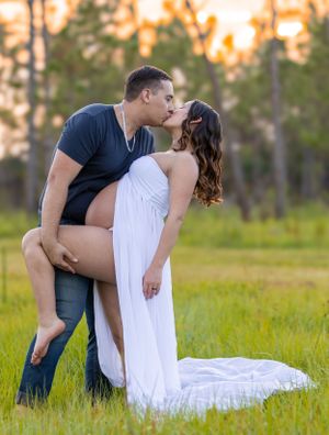 Romantic couple pose in grassy field during sunset maternity photoshoot. Geneva, Florida