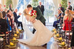 Wedding ceremony moment with candlelit aisle and dramatic dip. Lake Mary, Florida
