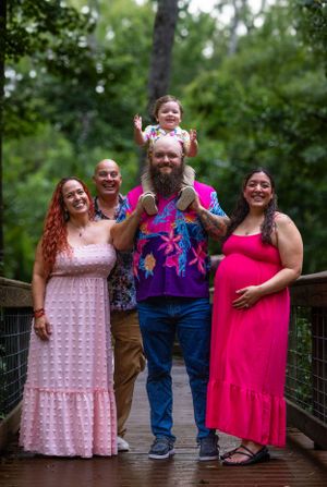 Group photo on wooden bridge with coordinating pink and purple outfits. Geneva, Florida