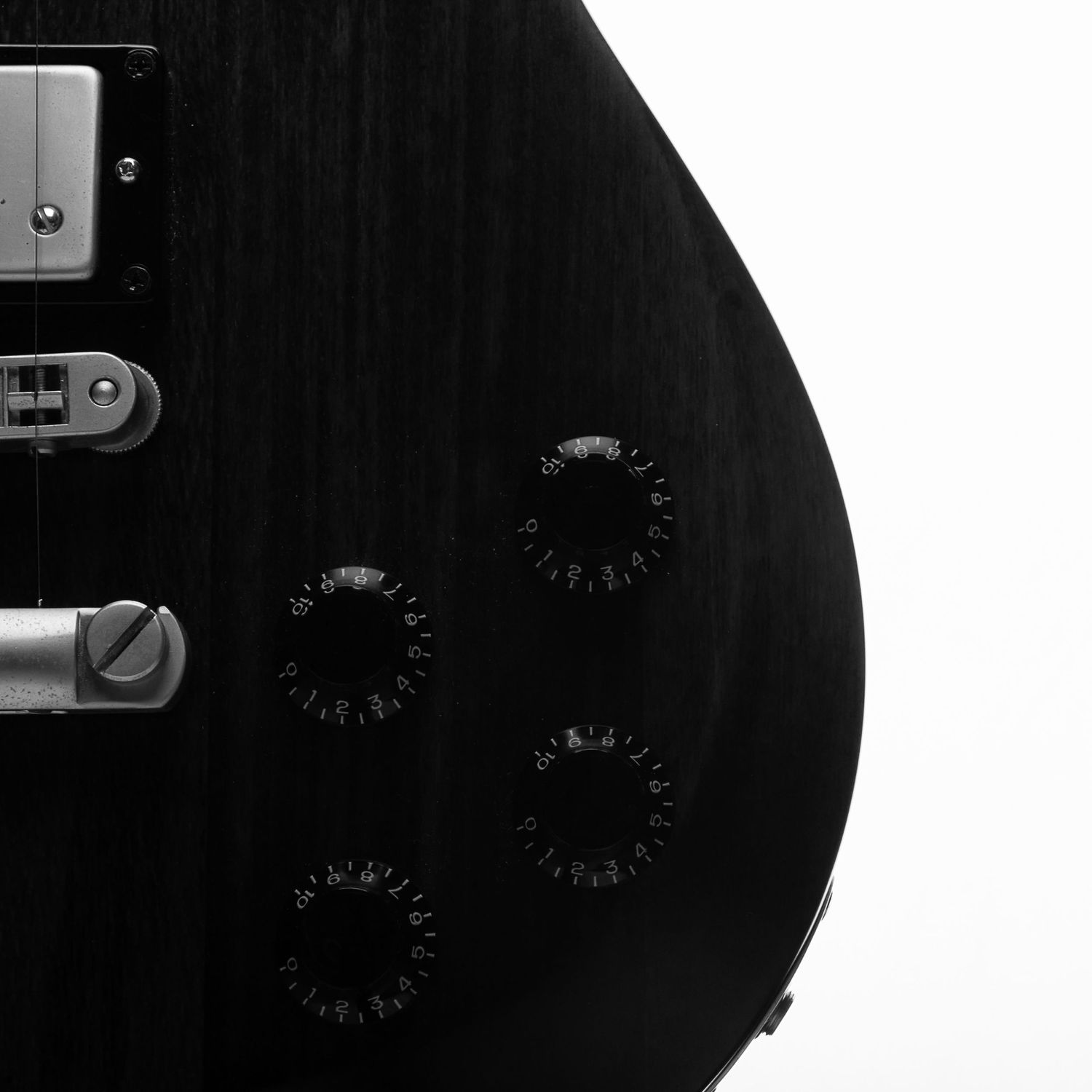 Electric guitar control dials, pickups, and bridge in b&w