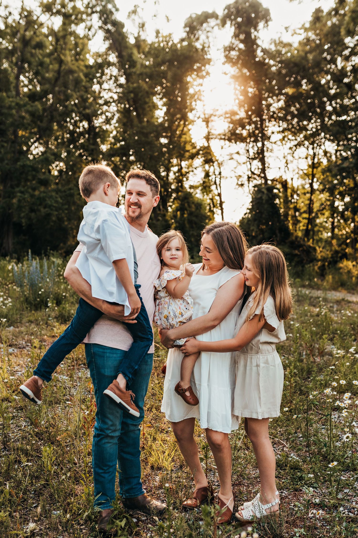 Cute family wearing a neutral color palette for their outdoor family session