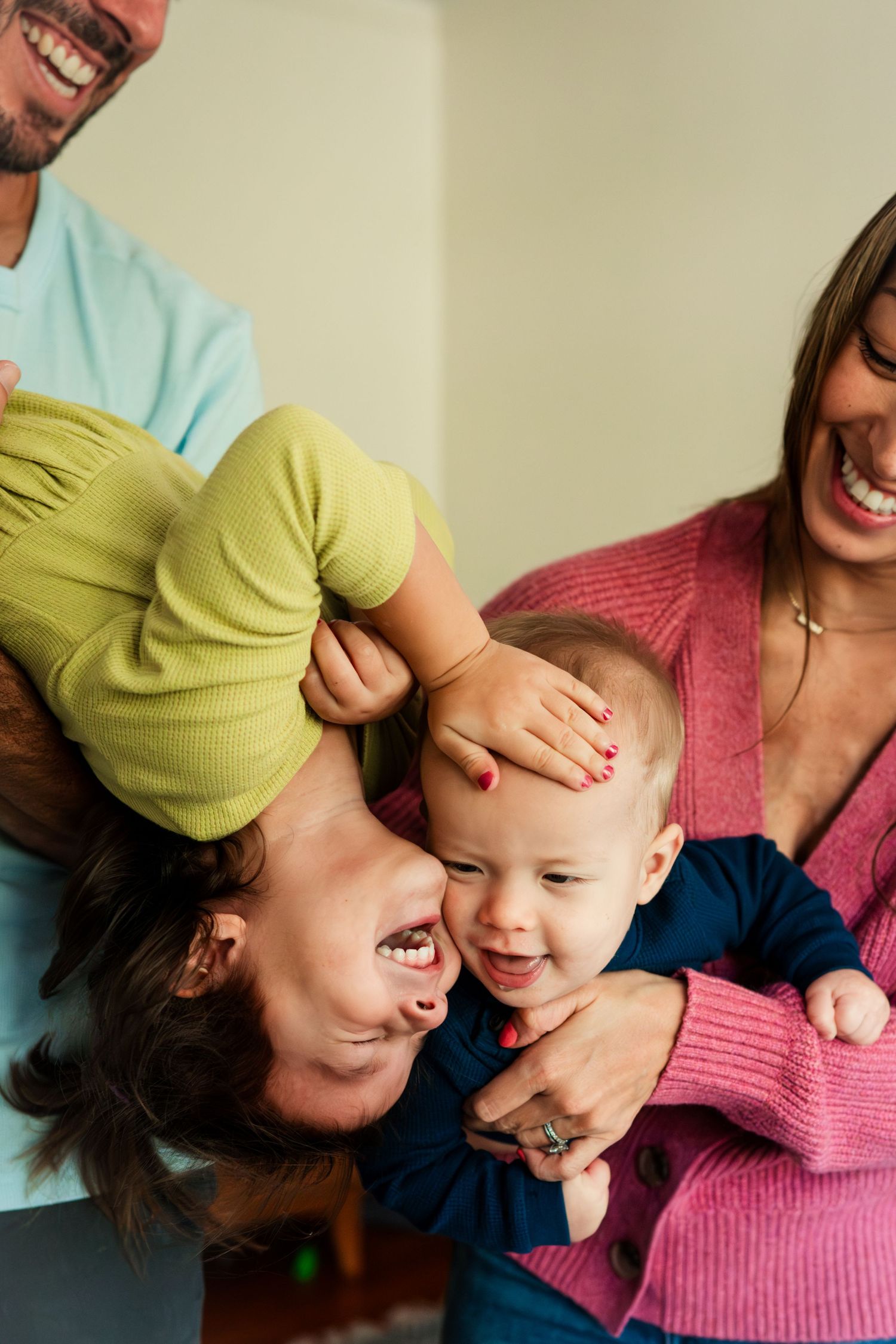 Joyful family moment showing playful interaction on a light background.