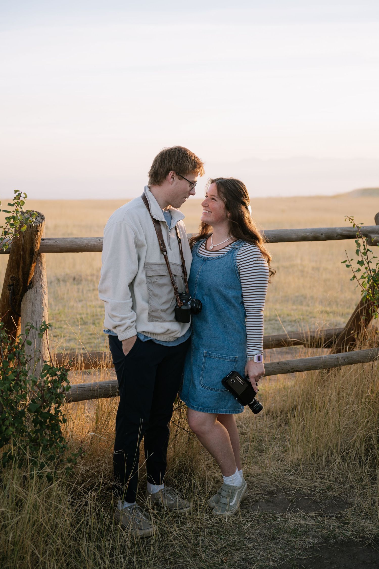 Portrait of Taylor and Ian Steadman, husband-and-wife wedding filmmakers, captured in a candid moment reflecting their vintage-inspired, aut