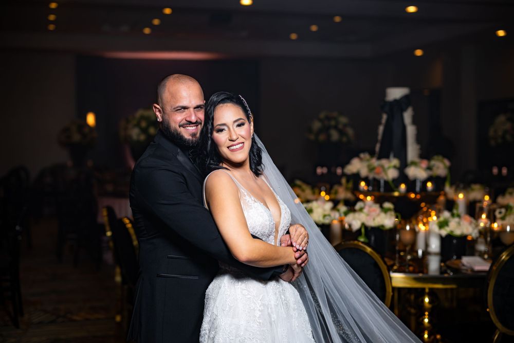 A reception portrait shows the newlyweds embracing with elegant decor and lighting in the background.