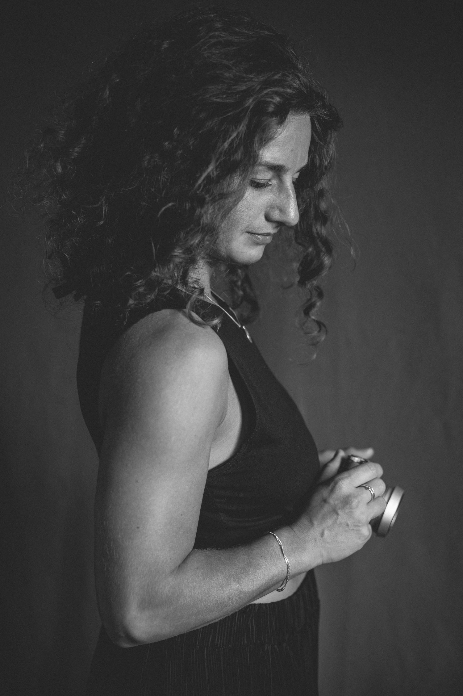 Black and white portrait of photographer holding vintage camera.