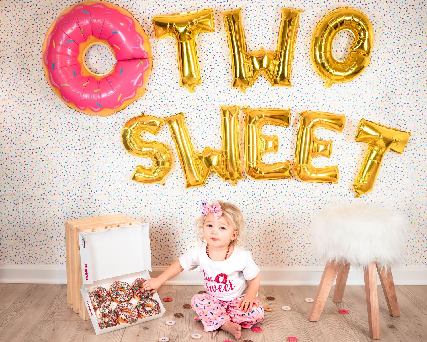 Festive birthday celebration with pink and gold balloon decorations.