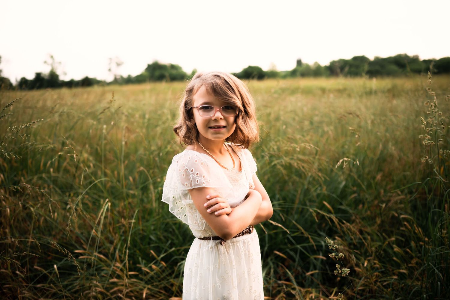 Candid moments captured in golden field during sunset.